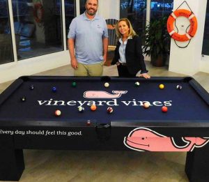 Shep Murray and Robbie Selby posing in front of Vineyard Vine's custom all weather, outdoor pool table
