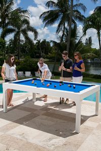 Family enjoying a Balcony outdoor pool table in Southwest Florida made by R&R Outdoors, Inc. All Weather Billiards