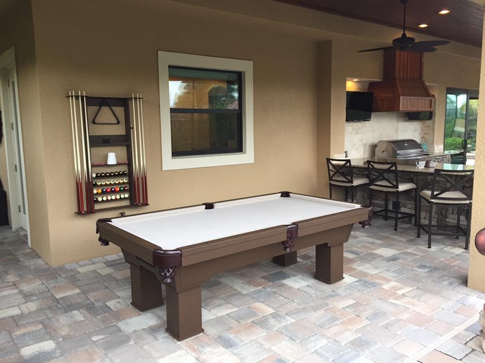 Caesar custom pool table with wall mounted cue rack in client's outdoor living space
