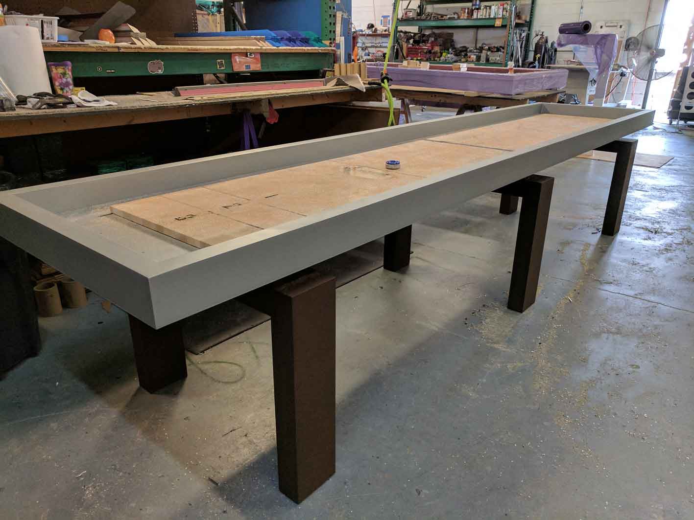Custom outdoor shuffleboard table in production at R&R Outdoors All Weather Billiards manufacturing facility