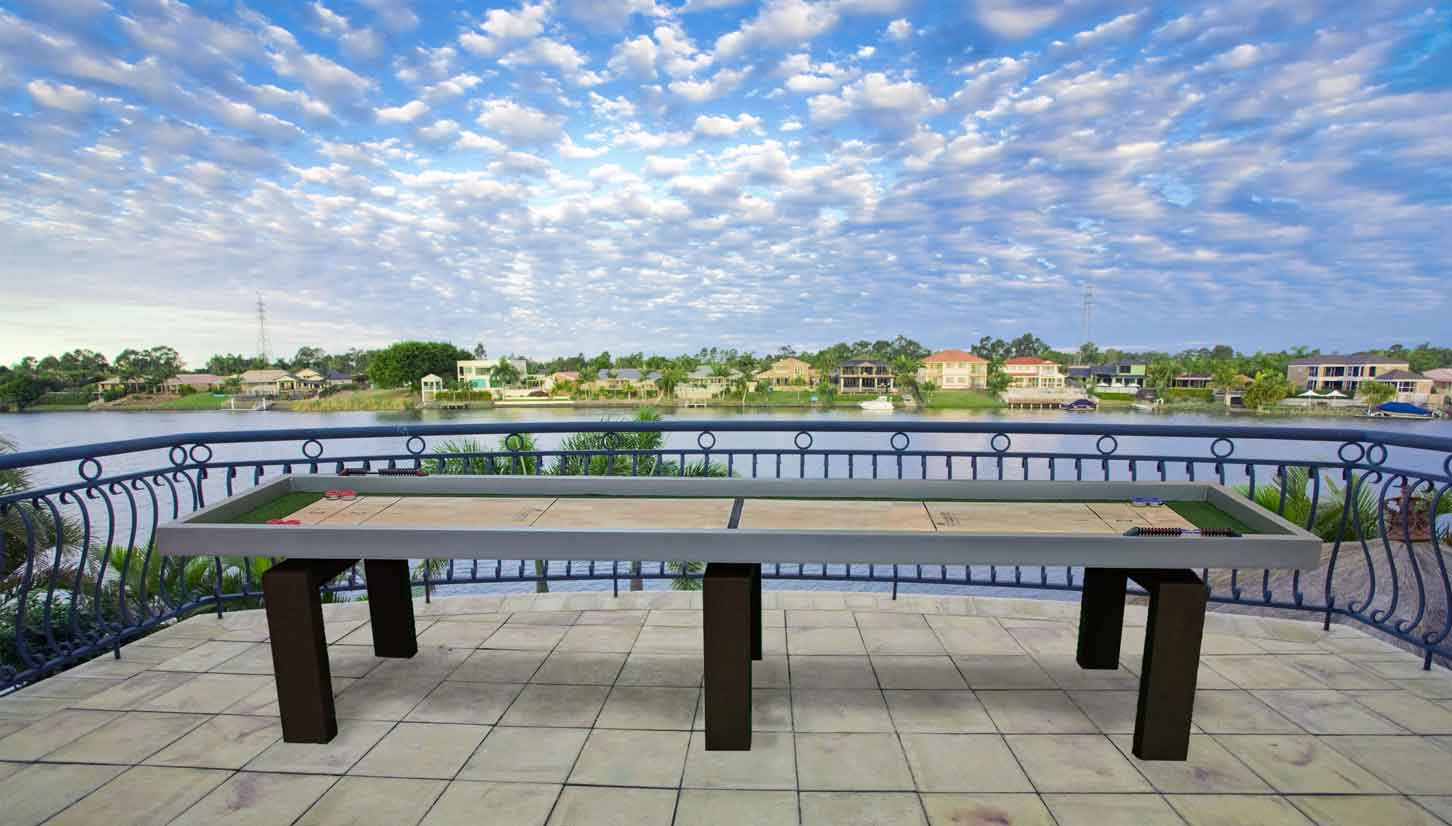 Outdoor Shuffleboard game table on patio overlooking the water